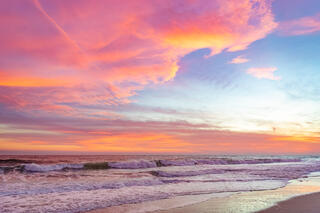 Pink, orange, and yellow beach sunset.