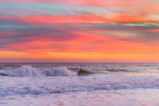 Crashing wave at peak sunset.