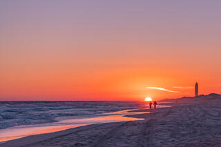 Couple at the beach with the sun.